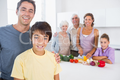 Father and son standing by kitchen counter