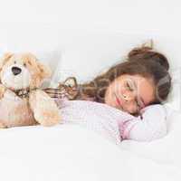 Little girl sleeping with teddy bear