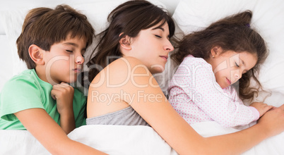 Mother sleeping with son and daughter
