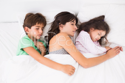 Mother asleep with her children