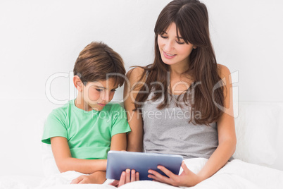 Mother and son using tablet pc