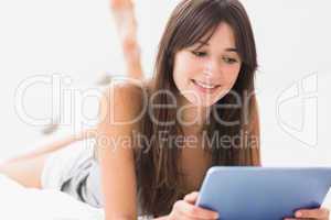 Smiling woman using digital tablet