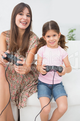 Mother and daughter playing video games