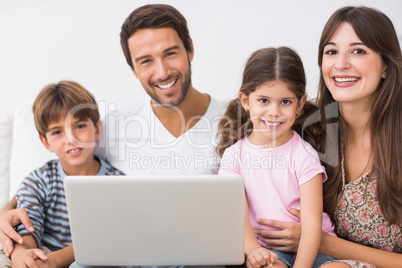 Happy family with laptop