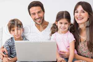 Happy family with laptop