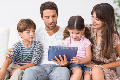 Happy family looking at tablet pc