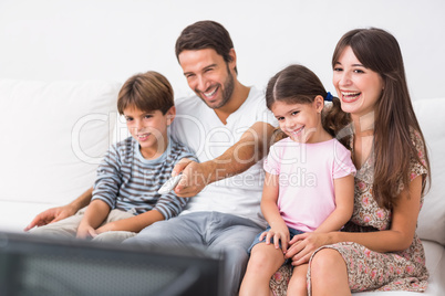 Happy family watching television