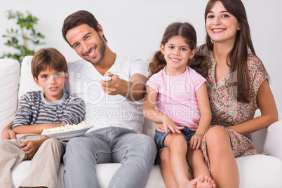 Happy family watching television together Happy family watching television together