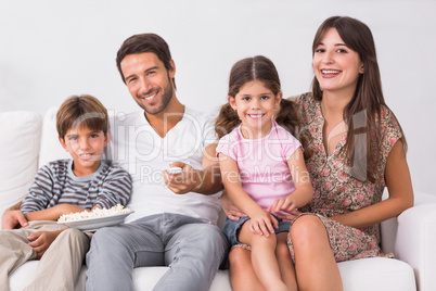 Smiling family watching the television