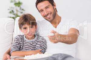 Father and son watching television