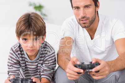 Father and son playing video games together