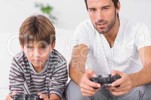 Father and son playing video games together