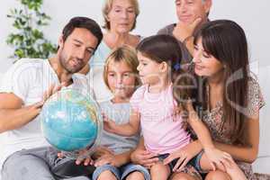 Happy family looking at globe