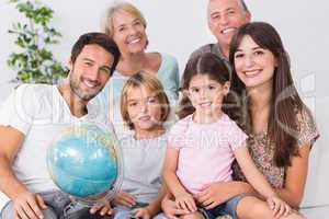 Smiling family with globe
