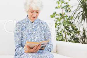 Elderly woman reading a old book