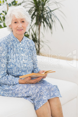 Elderly woman reading a old novel