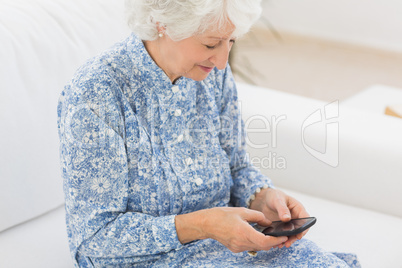 Elderly cheerful woman using a smartphone