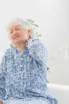 Elderly woman suffering with a neck pain