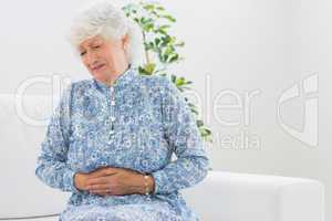 Elderly woman having a belly pain