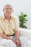 Elderly man sitting on the sofa