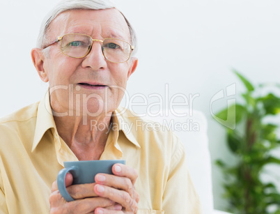 Elderly man with a cup