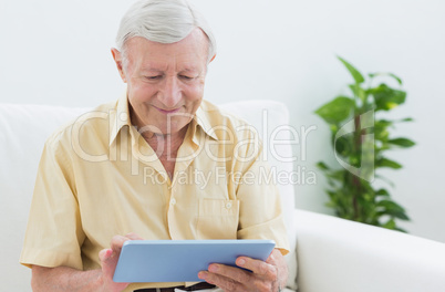 Elderly man using a digital tablet
