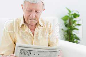 Elderly calm man reading newspapers