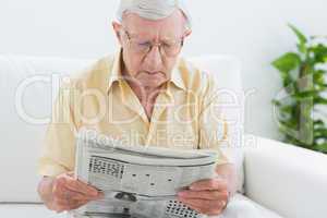 Focused aged man reading the news