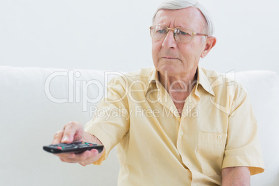 Elderly man using the remote