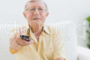 Concentrated elderly man using the remote