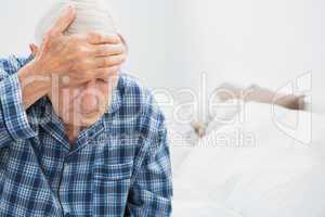 Elderly man suffering on the bed