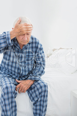 Old man suffering on the bed