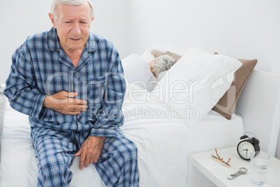 Elderly man suffering with belly pain