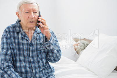 Old man on the phone sitting