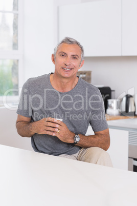 Smiling man holding a cup