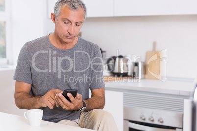 Focused man touching his smartphone