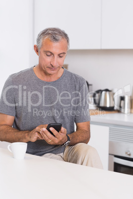 Mature man touching his smartphone