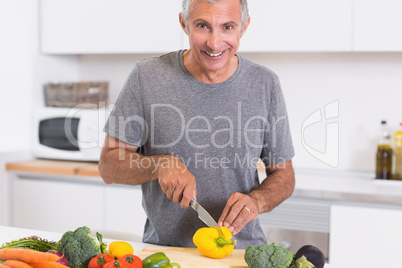 Man cutting a yellow pepper