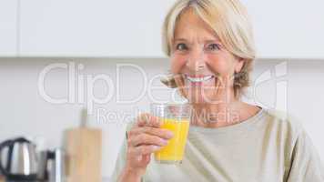 Mature woman drinking orange juice