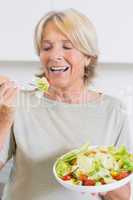 Mature woman eating salad