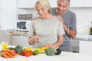 Couple cutting vegetables together