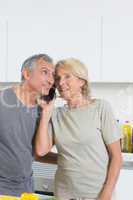 Mature couple listening a call together