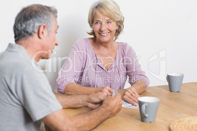 Happy couple playing cards