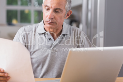 Mature man using his laptop