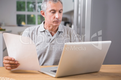 Calm mature man using his laptop