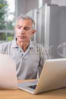 Thoughtful man using his laptop