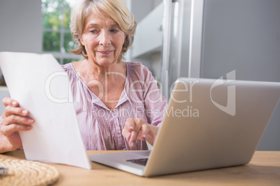 Stern mature woman using her laptop