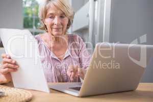 Stern mature woman using her laptop