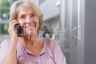 Happy mature woman calling