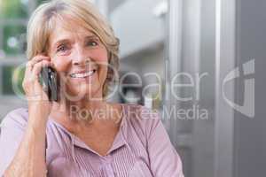 Happy mature woman calling